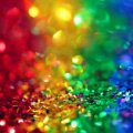 Piles of sequins in the colours of the rainbow flag. Image: Pexels/Sharon McCutcheon
